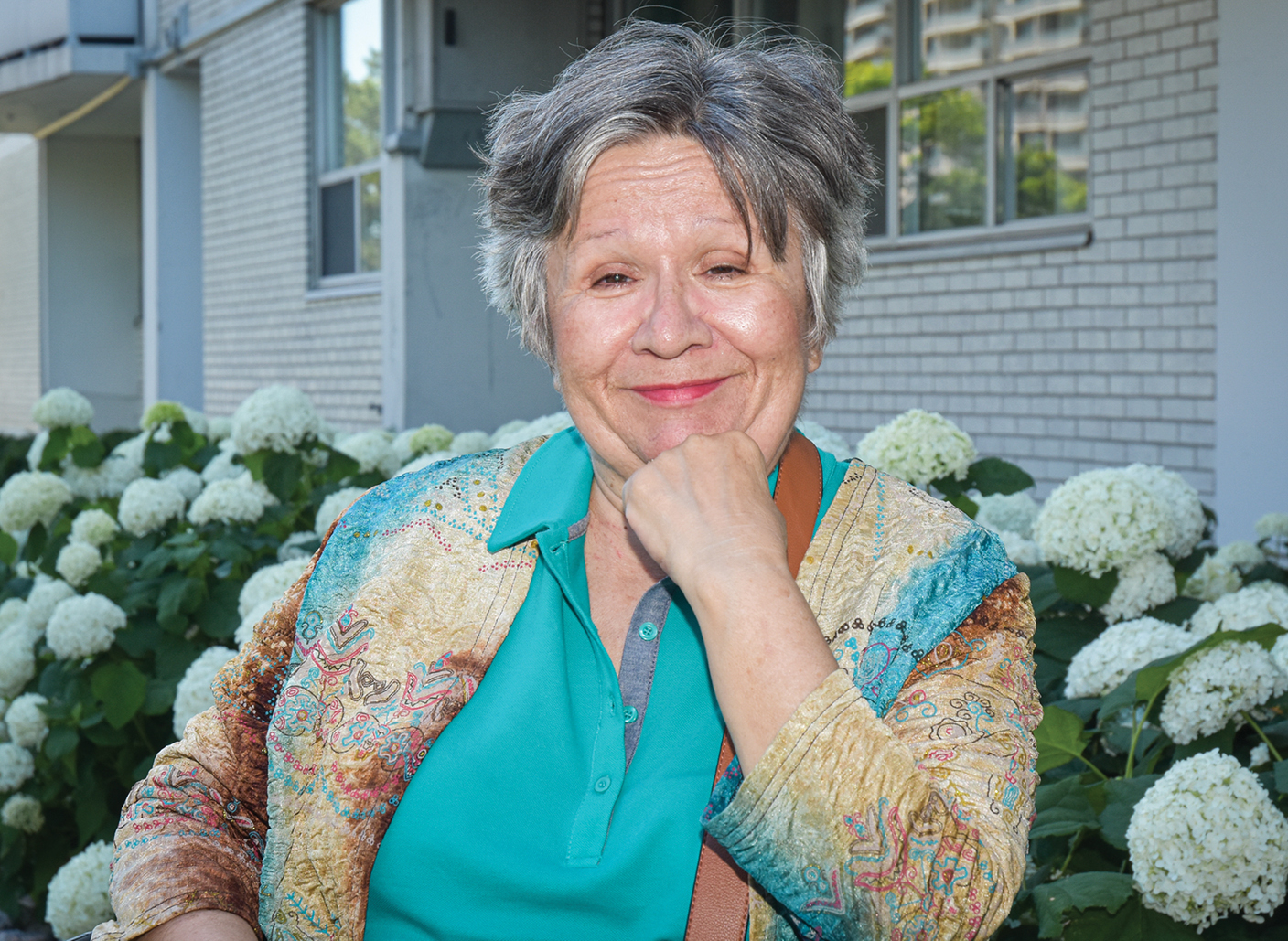 smiling elderly woman in her backyard