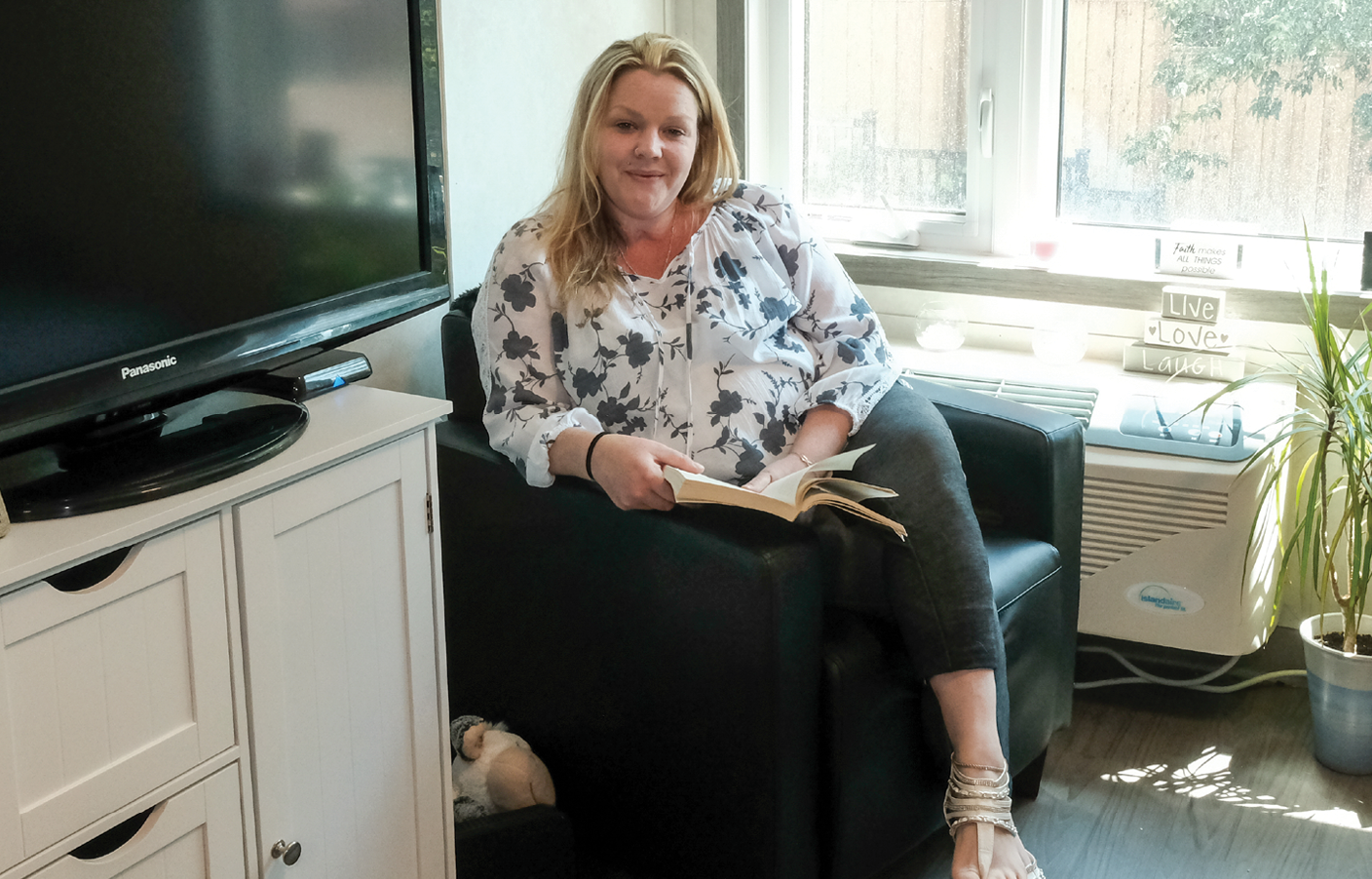 woman relaxing in her modular housing apartment