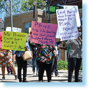 people marching in support of personal support workers' pay