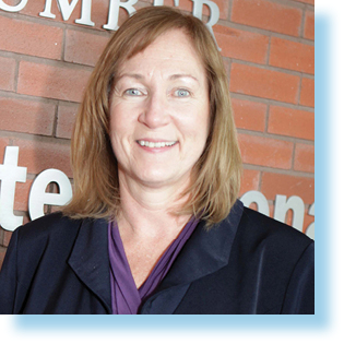 smiling woman in front of Humber College sign