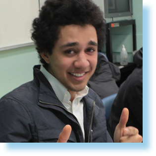 young man smiling in a classroom