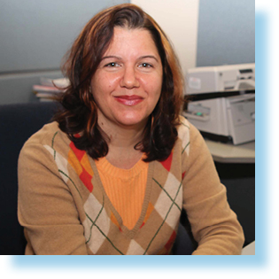 Woman sitting at a desk smiling