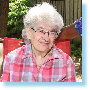 elderly woman sitting in garden