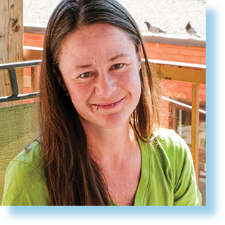 smiling woman on a balcony