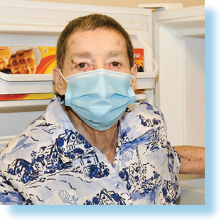 woman in front of open fridge