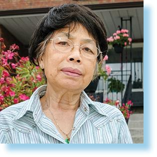 elderly woman standing in garden