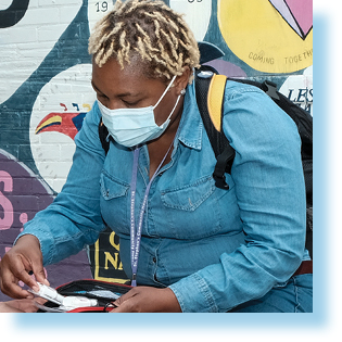 woman speaking in front of wall with graffiti