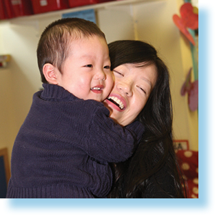 smiling woman holding her young son