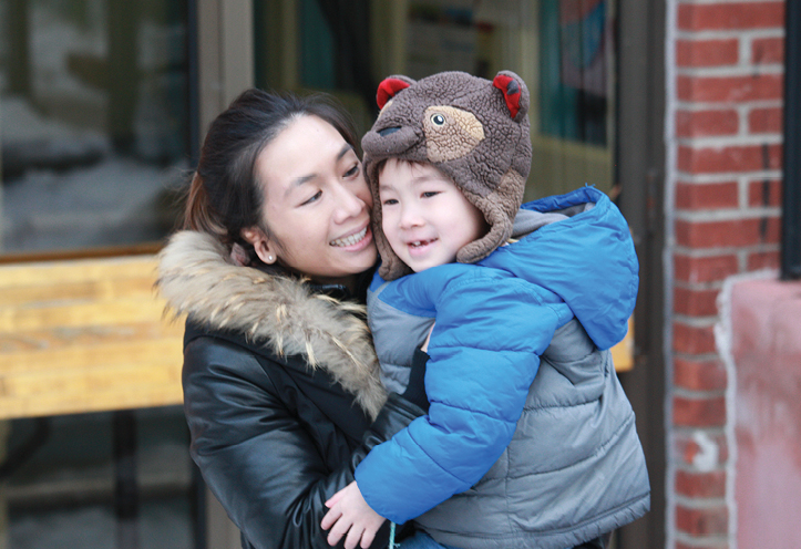 Woman hugging her young son