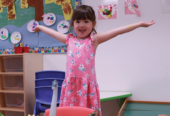 Girl posing for photo with arms wide open