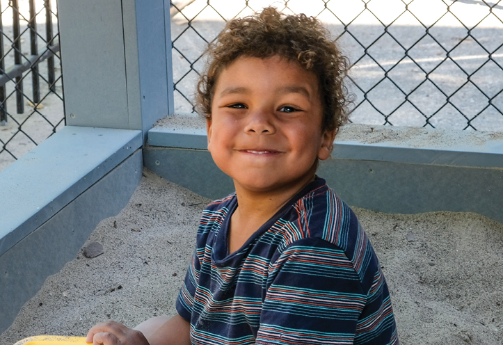 boy playing in a sandbox