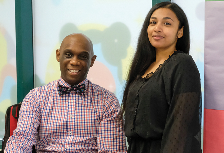 Man sitting and woman standing next to him