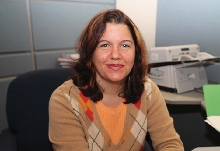 Woman sitting at a desk smiling