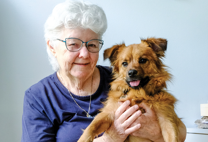 Woman holding her pet dog