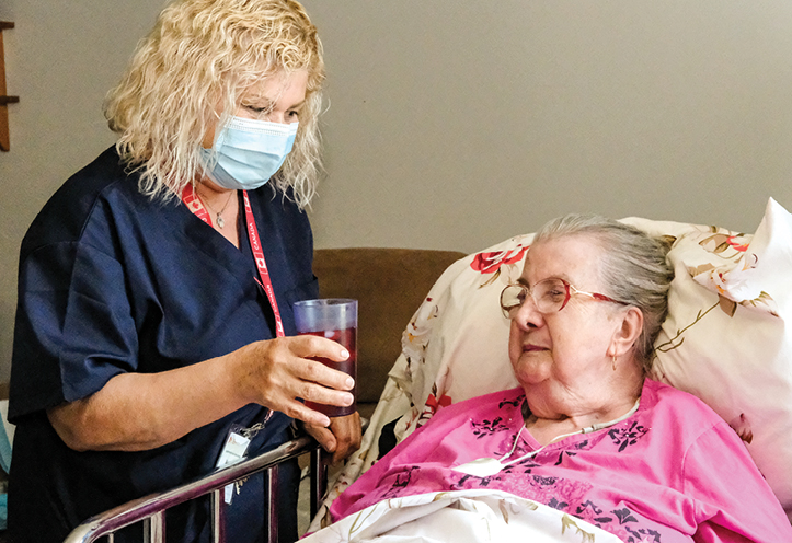 A woman PSW serving a senior woman