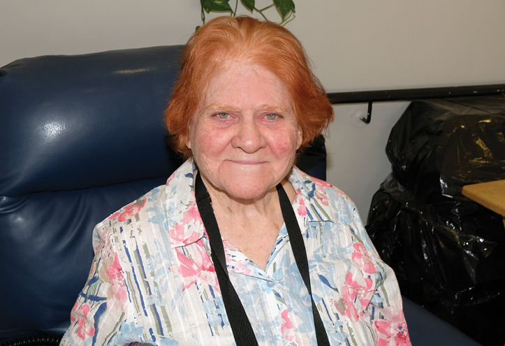 elderly woman sitting on couch