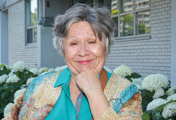 Woman smiling with fist against her chin