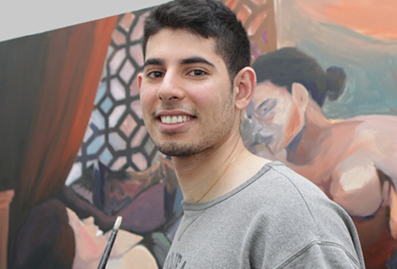 youth in front of his painting in the Youth Arcade Studio