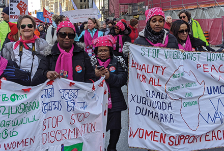 women marching to stop violence against women