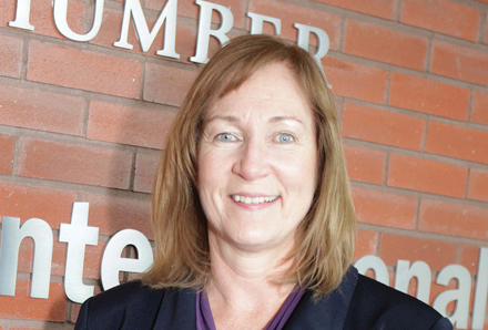 woman standing in front of Humber College building where the organization received conflict coaching and mediation services