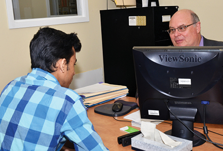 man working with employment staff member