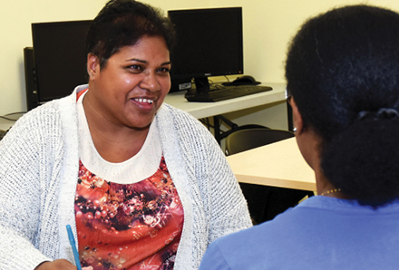 Woman talking to staff in the Moving Forward employment program