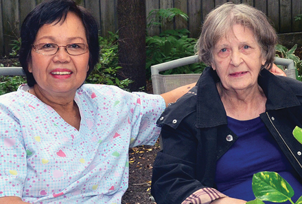 resident and caregiver in the Jean Dudley residence backyard