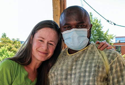 woman standing on balcony with personal support worker