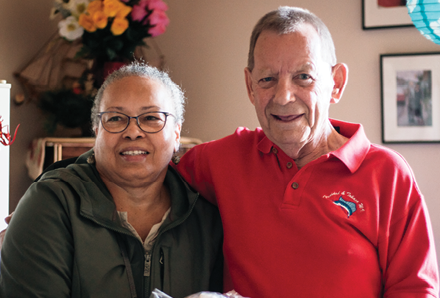 volunteer standing with a senior