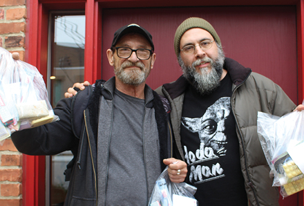 two men standing in front of a door