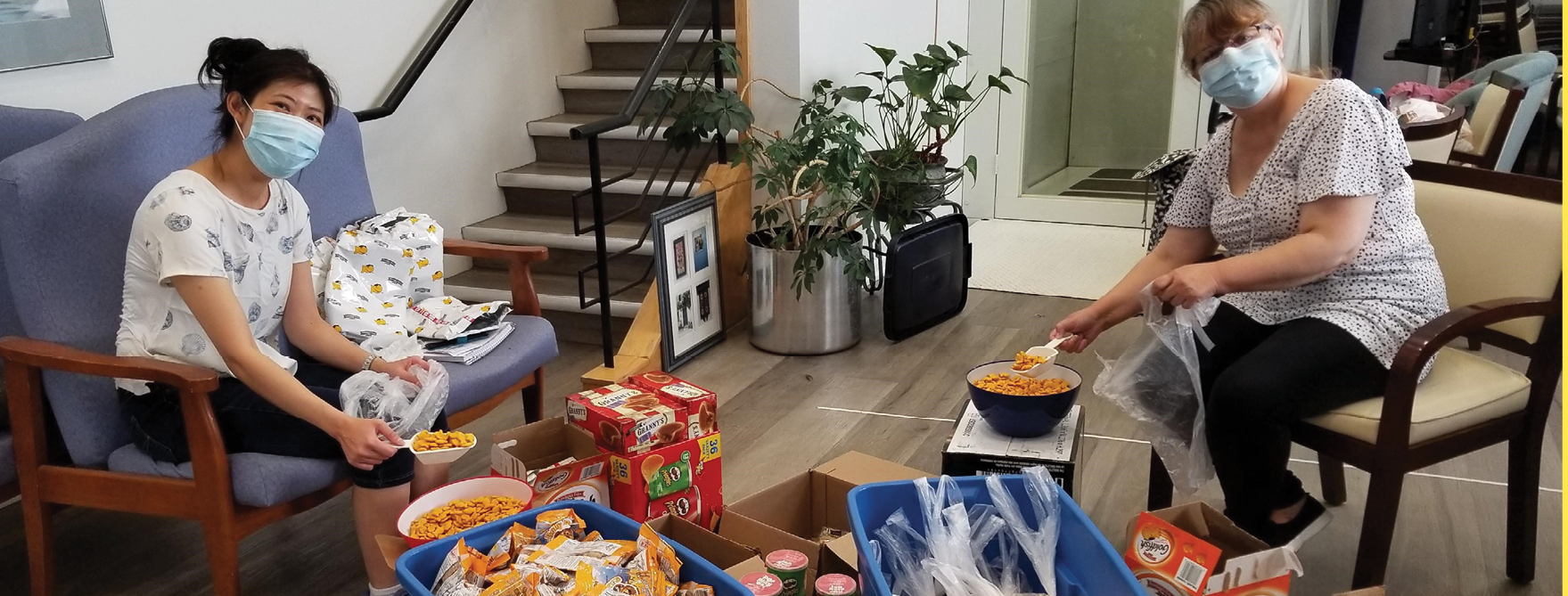 staff with packaged food to distribute to supportive housing residents