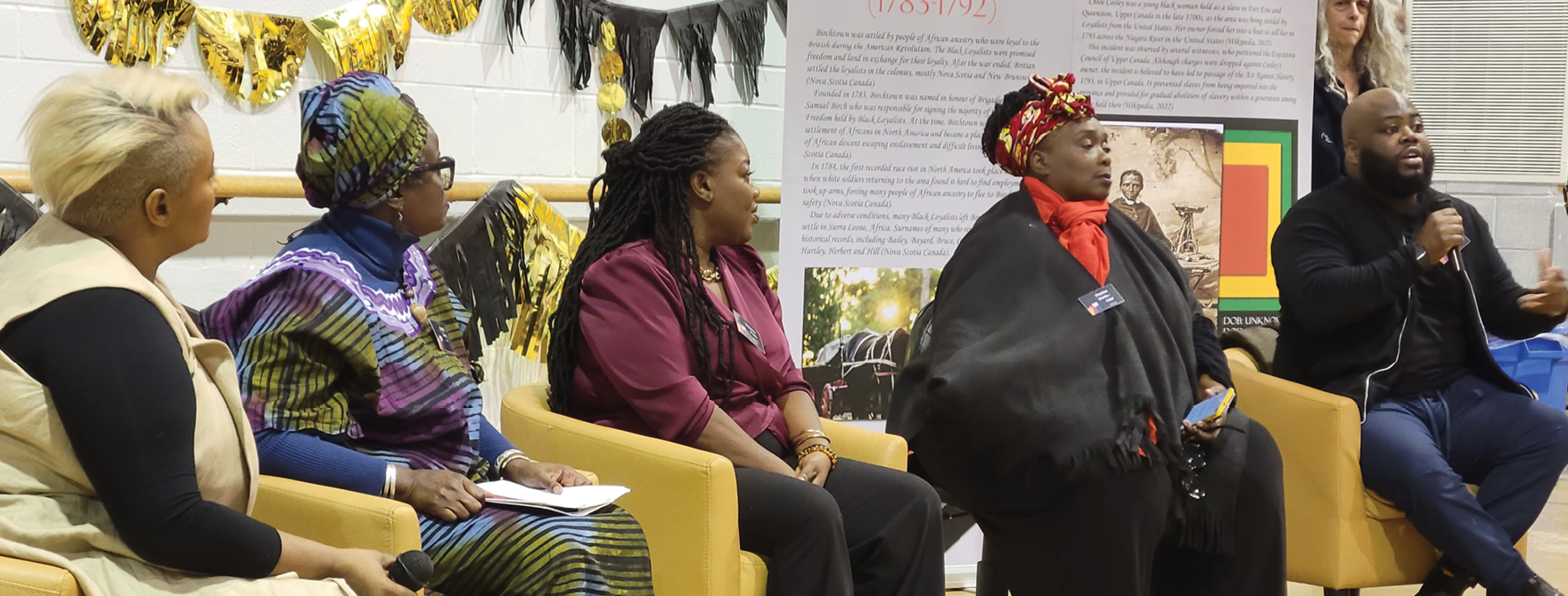 speakers at a forum for Black History Month