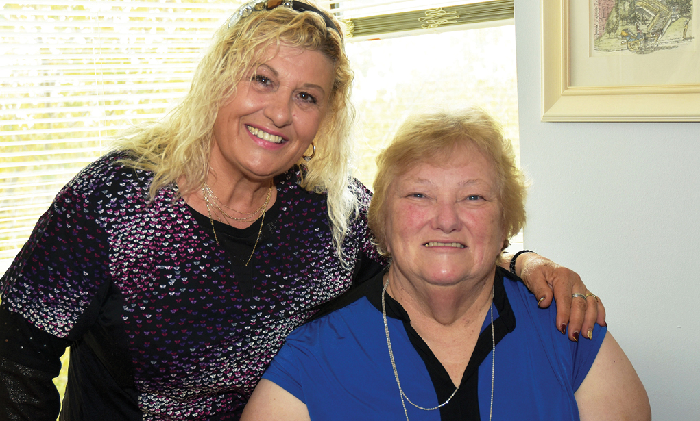 smiling elderly woman with caregiver