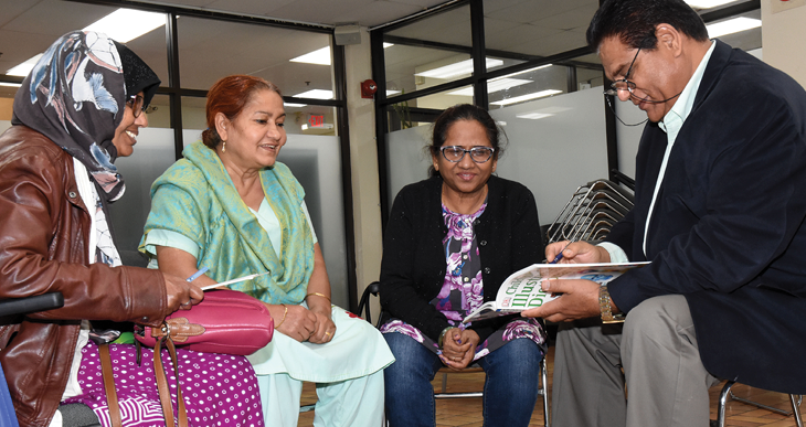 women and man reading and talking