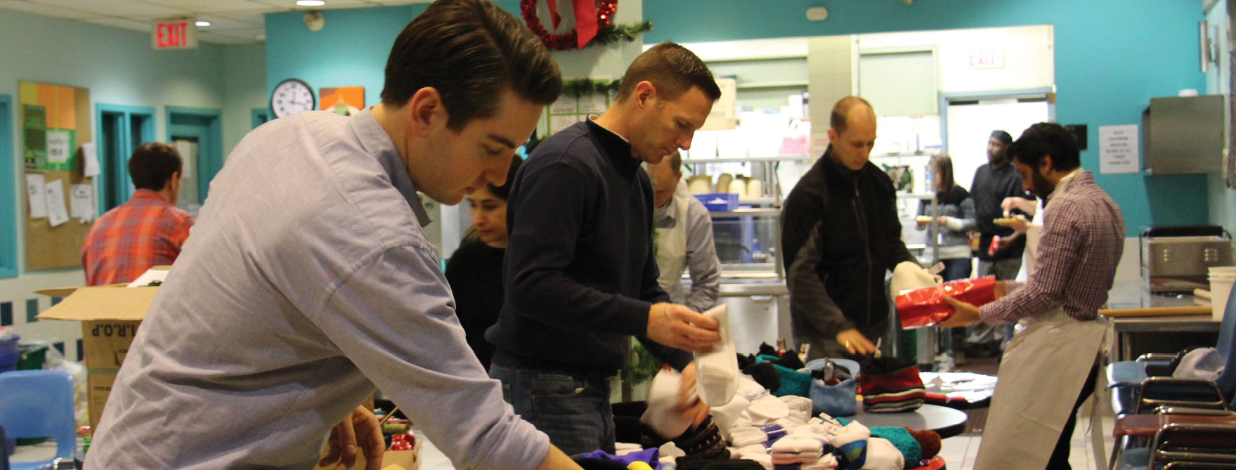 Volunteers from Ironbridge Equity packing up gifts for people at our Corner Drop-in