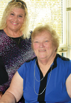 smiling elderly woman with caregiver