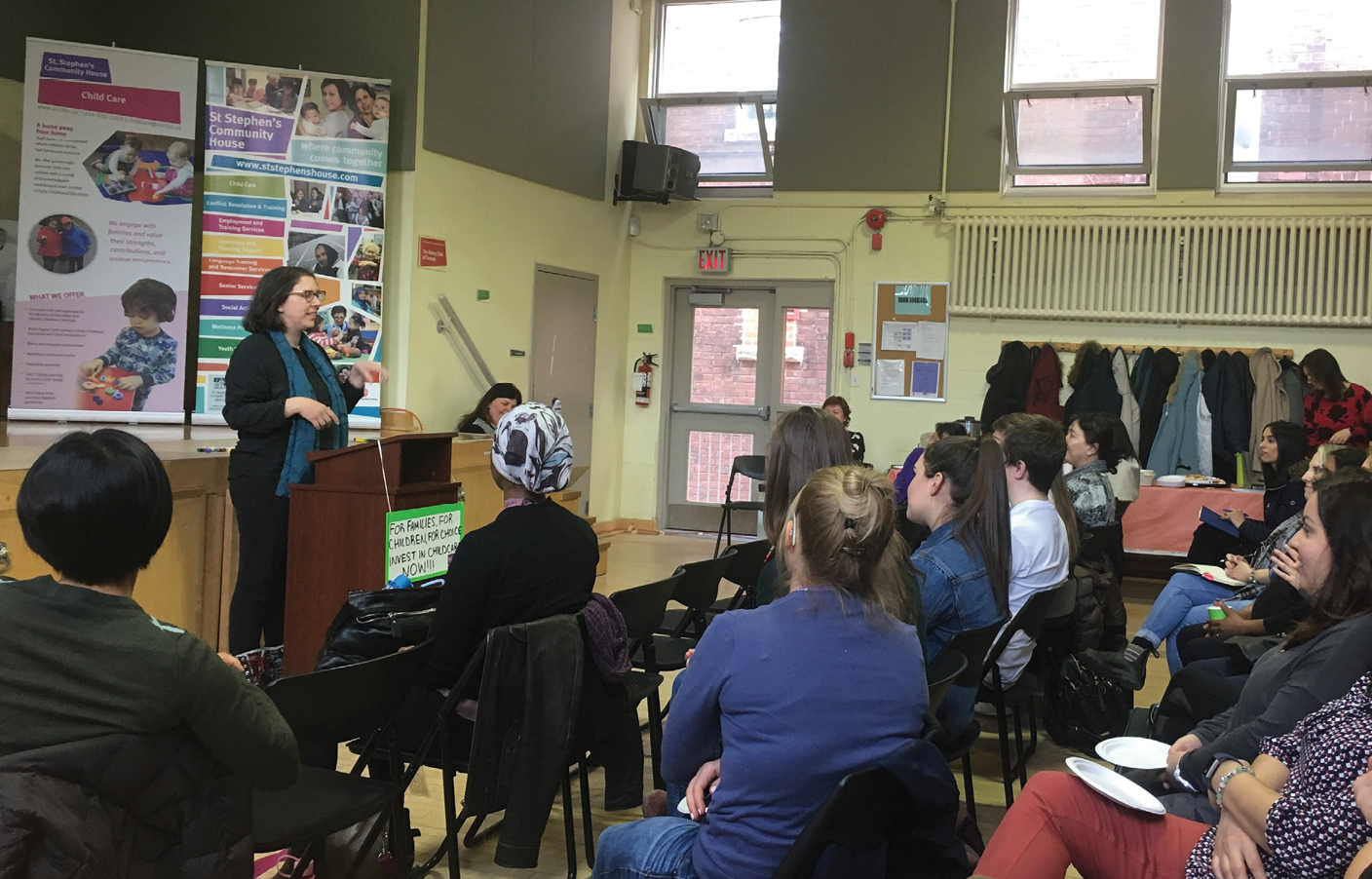 child care advocates speaking at a rally to create awareness about the need for affordable child care